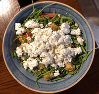 Fresh salad with roka, greek cheese "mizithra", small tasty fresh tomatoes and traditional greek paximadi with olive oil