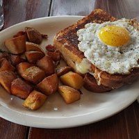 Croque Madame - 2 slices of french toast with ham and swiss cheese in between, with a fried egg on top