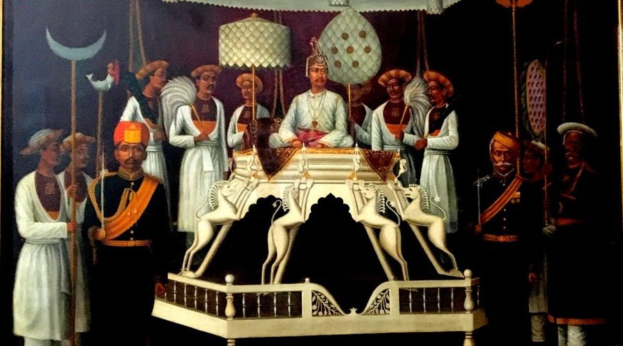 Museum displays - paintings of royalty on throne