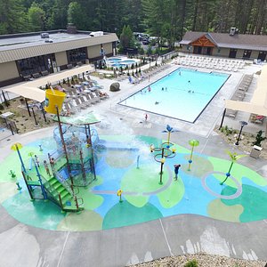Cascade Cove Aquatic Area - Featuring zero entry pool, splash pad with 32 spray features, twisting slide and dump bucket, along with a 38 person spa cluster. 