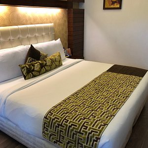Hotel Icon in Chandigarh, image may contain: Furniture, Bed, Painting, Art