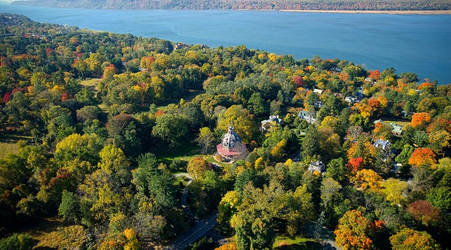 Aerial view of The Armour-Stiner Octagon House with Hudson River in background