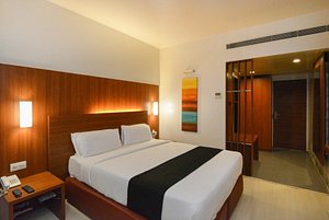 Orbett Hotel in Pune, image may contain: Hotel, Bed, Resort, Interior Design