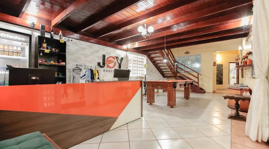 Reception/Front desk and welcoming game room with a pool table. Come play with us.