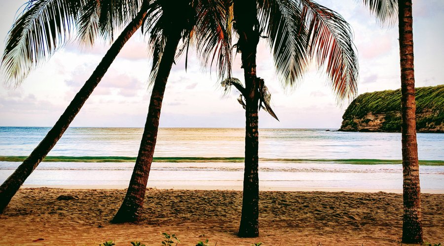 La Sagesse Beach and Bay at sunset before new development on the ridge.