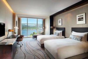 Sunrise Kempinski Hotel Beijing in Beijing, image may contain: Bed, Furniture, Bedroom, Monitor