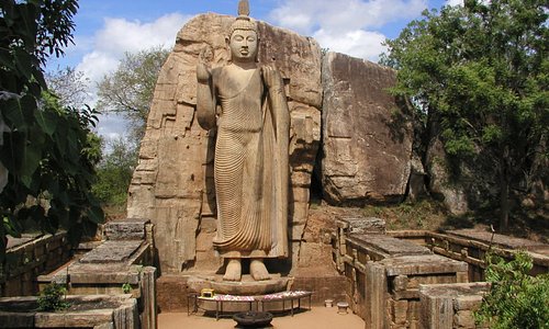 Aukana Buddha and kalawewa  The aukana Buddha statue is a standing statue location in the village of aukana near Kekirawa in North central province. The statue height more than 40feet, it caved out of a large granite rock during the 5th century. A narrow strip of rock has been left at the back of the statue but it is not completely separated. The Aukna Buddha statue is one of the best examples of a standing statue constructed in ancient Sri Lanka.