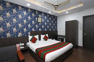 Hotel Flowers Inn in Kota, image may contain: Ceiling Fan, Furniture, Interior Design, Bedroom
