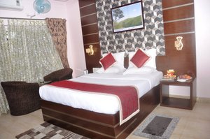 Hotel Mayura Riverview Srirangapatna in Srirangapatna, image may contain: Interior Design, Furniture, Bed, Bedroom