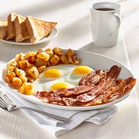 Five strips of premium bacon, three eggs, and home fries served with thick toast.