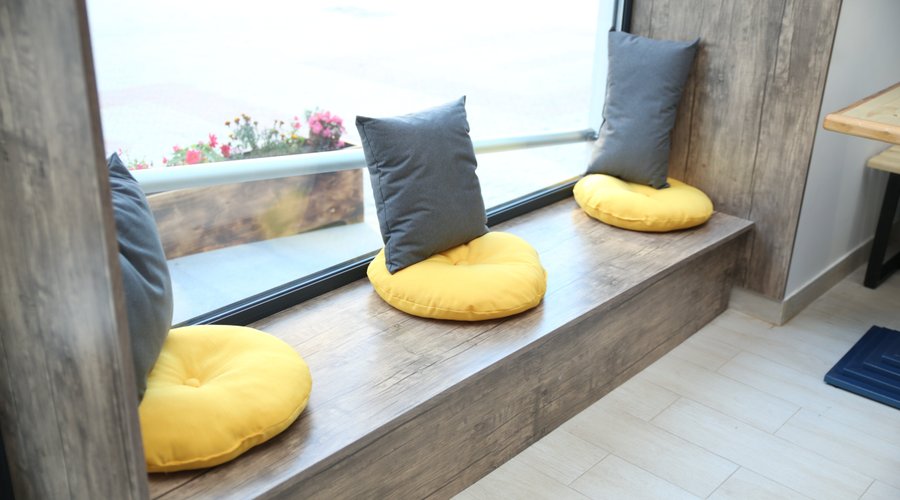 Choose a table or our cozy window seat.