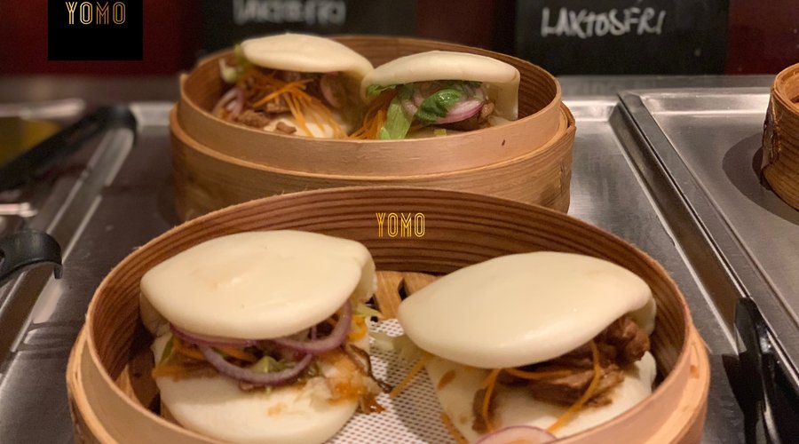 Chinese Burger Made by soft steamed bun with flavoured pork meat and vegetables. Really a different feeling.