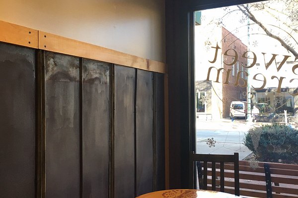 Glass of coffee with ice cream on rustic wooden board and steel