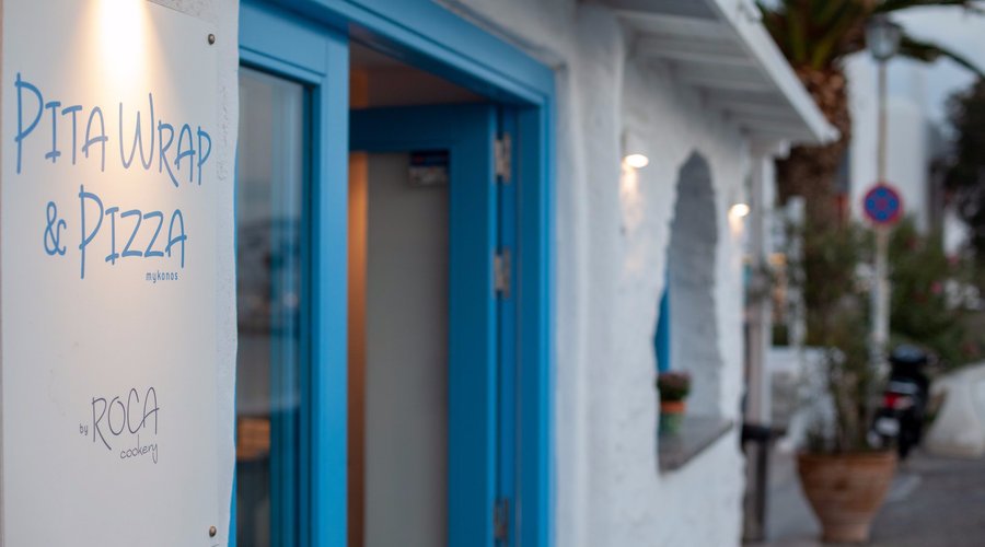 Overlooking Mykonos Yacht Marina and the picturesque town of Mykonos, the Gourmet Pita Wrap & Pizza Mykonos by Roca Cookery is going to change the fast food establishment on the island with it's modern design, friendly service and pure fresh ingredients!