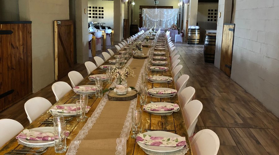 A banquet style wedding celebration set up in The Stables venue at 50 Shades of Hay.