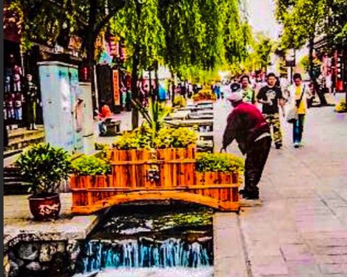 Waterways runs silently beneath showering willows through the old streets of Dali