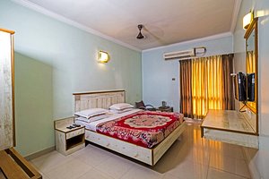 Legend's Inn in Coimbatore, image may contain: Interior Design, Furniture, Bed, Bedroom