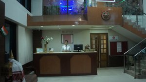 Hotel Lilawati Grand in Guwahati, image may contain: Table, Reception, Lighting, Person