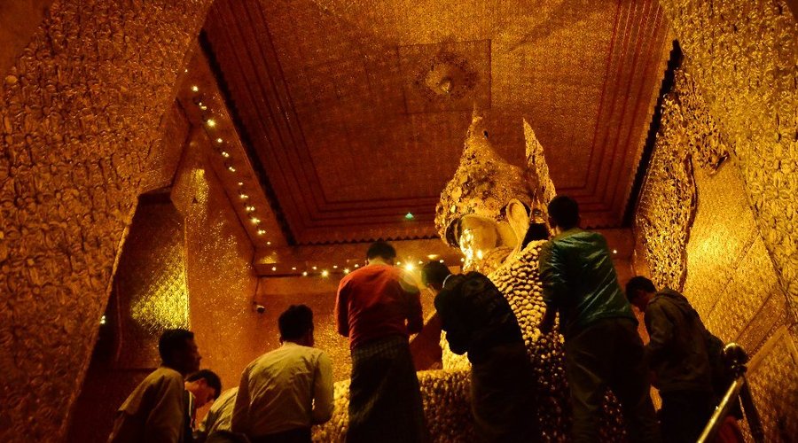 Mahamuni´s 13ft-tall seated Buddha,a nationally celebrated image that's popularly believed to be 2000years old.Centuries of votary gold leaf