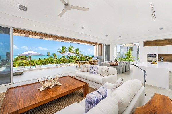 Luxury villa living area with open access to patio and pool deck.