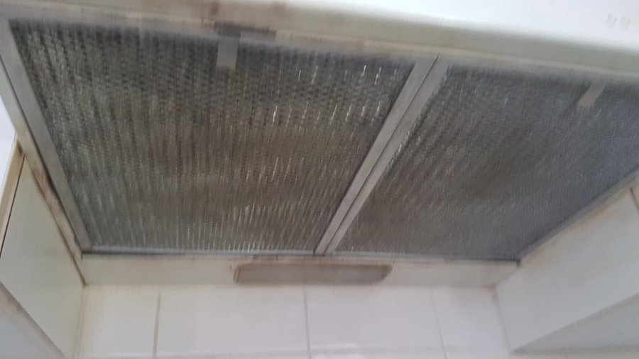 Filthy range hood over the stove