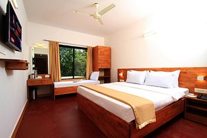 Hotel Dwara in Subrahmanya, image may contain: Ceiling Fan, Bedroom, Furniture, Monitor