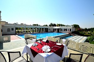 Aaram Baagh Pushkar in Pushkar, image may contain: Villa, Dining Table, Resort, Hotel