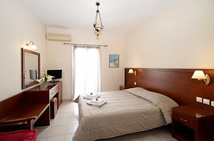 Hotel El Greco Sitia in Crete, image may contain: Furniture, Bedroom, Bed, Indoors
