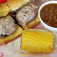 The Home of the Original Piglets served here with Fried Corn on the Cobb and BBQ Beans.