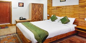 Treebo Trend Omega Stay Inn in Shillong, image may contain: Interior Design, Indoors, Wood, Bed