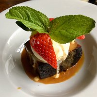 Sticky Toffee Pudding served with ice cream and caramel sauce with a garnish of strawberry and mint. The best desert to be found in the Winchester area, but beware, it is very filling!