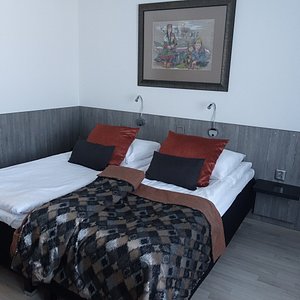 Visit Inari Hotel in Inari, image may contain: Bed, Interior Design, Cushion, Painting