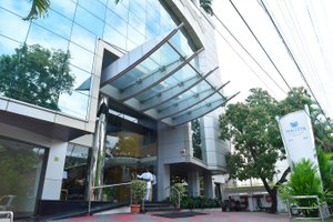Maurya Rajadhani in Thiruvananthapuram (Trivandrum), image may contain: Office Building, City, Convention Center, Plant