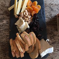 Cheese plate with Comté, blue and triple cream cheeses, dried fruit, marcona almonds and baguette.
