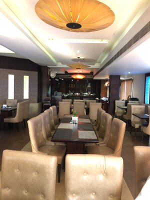 Hotel Amber Residency in Hoshiarpur, image may contain: Dining Room, Dining Table, Table, Indoors