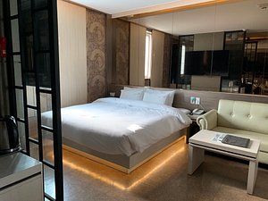 Airport Hotel in Busan, image may contain: Furniture, Couch, Bed, Bedroom