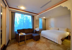 YoMi Hotel in Zhongshan District, image may contain: Corner, Bed, Furniture, Couch