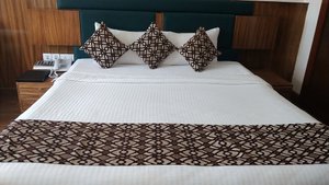 The Gokulam Park in Kaloor, image may contain: Bed, Furniture, Bedroom, Home Decor