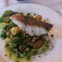 Coley fillet with crispy skin, new potatoes, little gem, peas, herb butter sauce