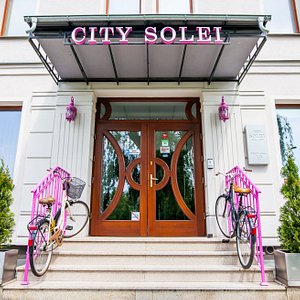 City Solei Boutique Hotel in Poznan, image may contain: Potted Plant, Plant, Purple, Bicycle