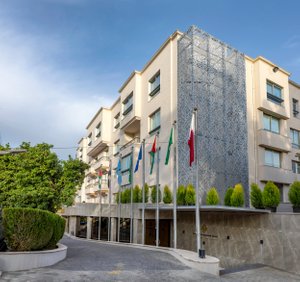 Amman International Hotel in Amman, image may contain: City, Apartment Building, High Rise, Urban