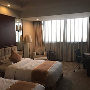Xiangmei International Hotel in Wuxi, image may contain: Bed, Furniture, Chair, Lamp