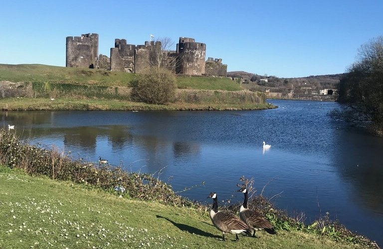 Caerphilly Castle is an impressive Welsh castle with thick battlements, a moat and bags of history - Read more in my article on the blog https://www.heatheronhertravels.com/things-to-do-in-south-wales-the-valleys/