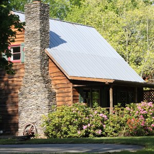 The Duck Tavern cabin is located near the stream, sleeps 4 to 7 people, and includes a fireplace, Wi-Fi, fully appointed kitchen and more!