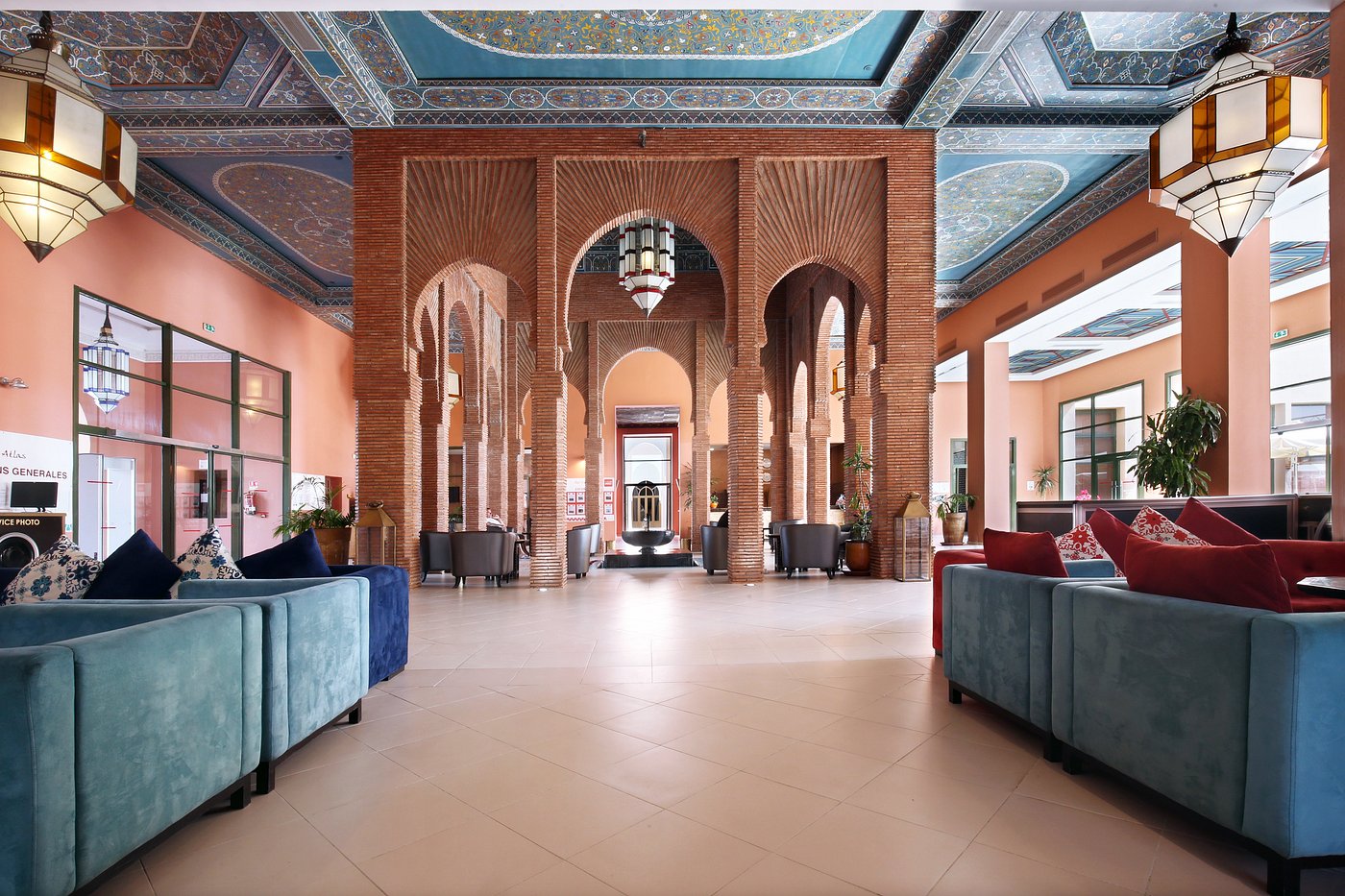 Elegant lobby with arched brick columns, colorful ceiling, and comfortable seating areas.