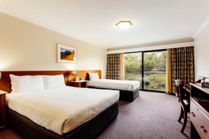 Cradle Mountain Hotel in Cradle Mountain-Lake St. Clair National Park, image may contain: Chair, Furniture, Bed, Bedroom