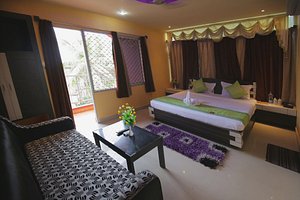 Hotel Pushpa in Puri, image may contain: Bed, Furniture, Home Decor, Couch