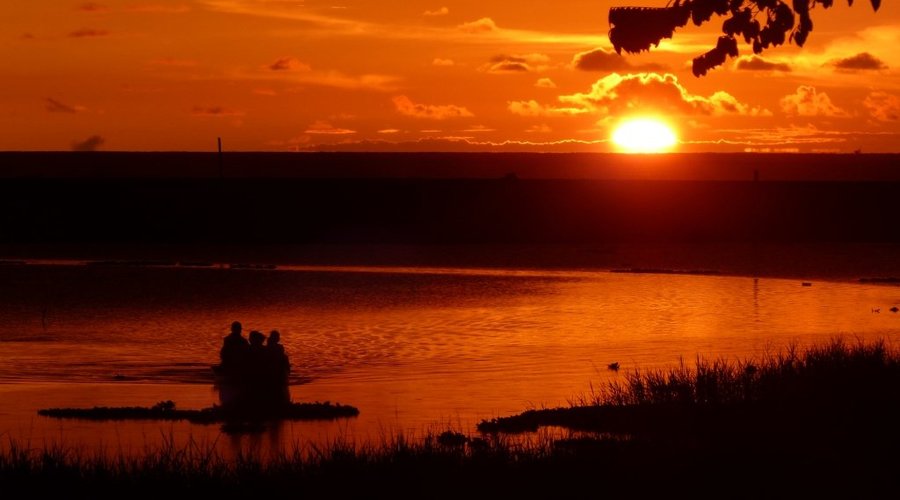 sunsets at Encanto Lodge over lagoon/beach/sea by canoe