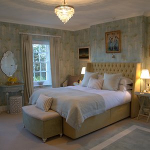 The Colefax and Fowler tumbling white wisteria wall paper gives this room a calming tranquillity. From the sumptuous Hypnos bed with Egyptian cotton sheets you can see the Dorset coast laid out before you through the two large sash windows. Indulge in the Au Lait products in the luxurious bathroom which has a large double ended claw-foot bath and a shower
over.