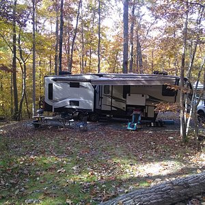Large fifth wheel on wooded Full Hook-Up site.